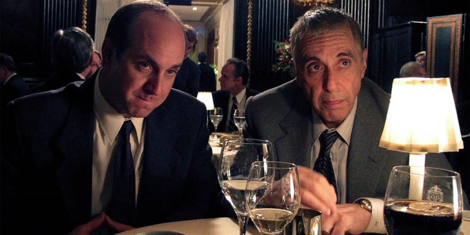 Two men in a restaurant in suits in Angels in America.