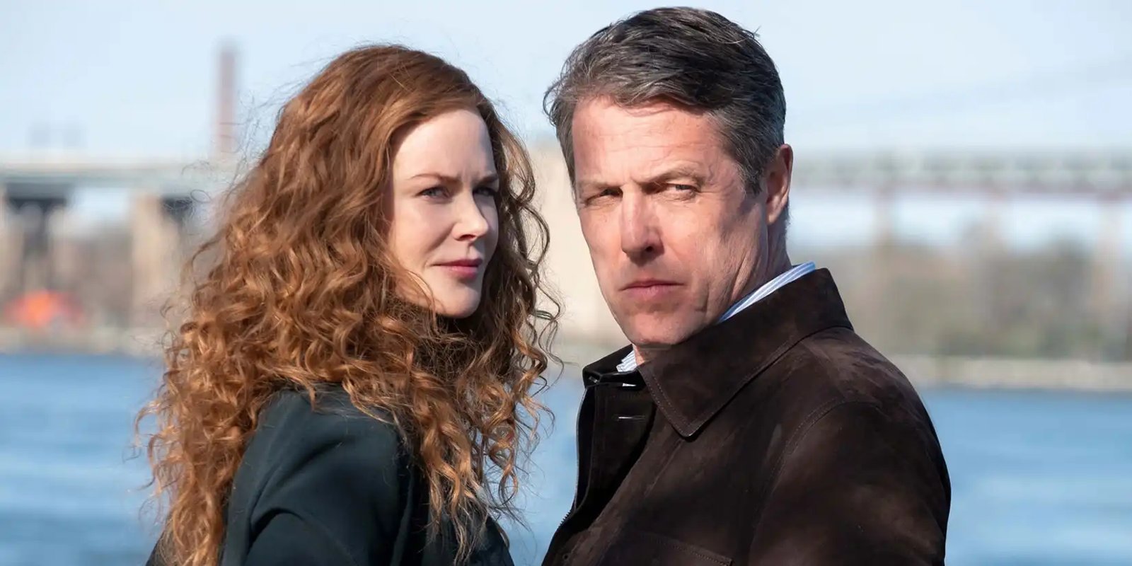 A man and woman standing by the water in The Undoing.